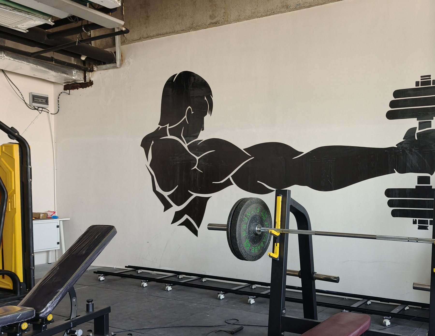 Single-color athletic figure printed onto a gym wall