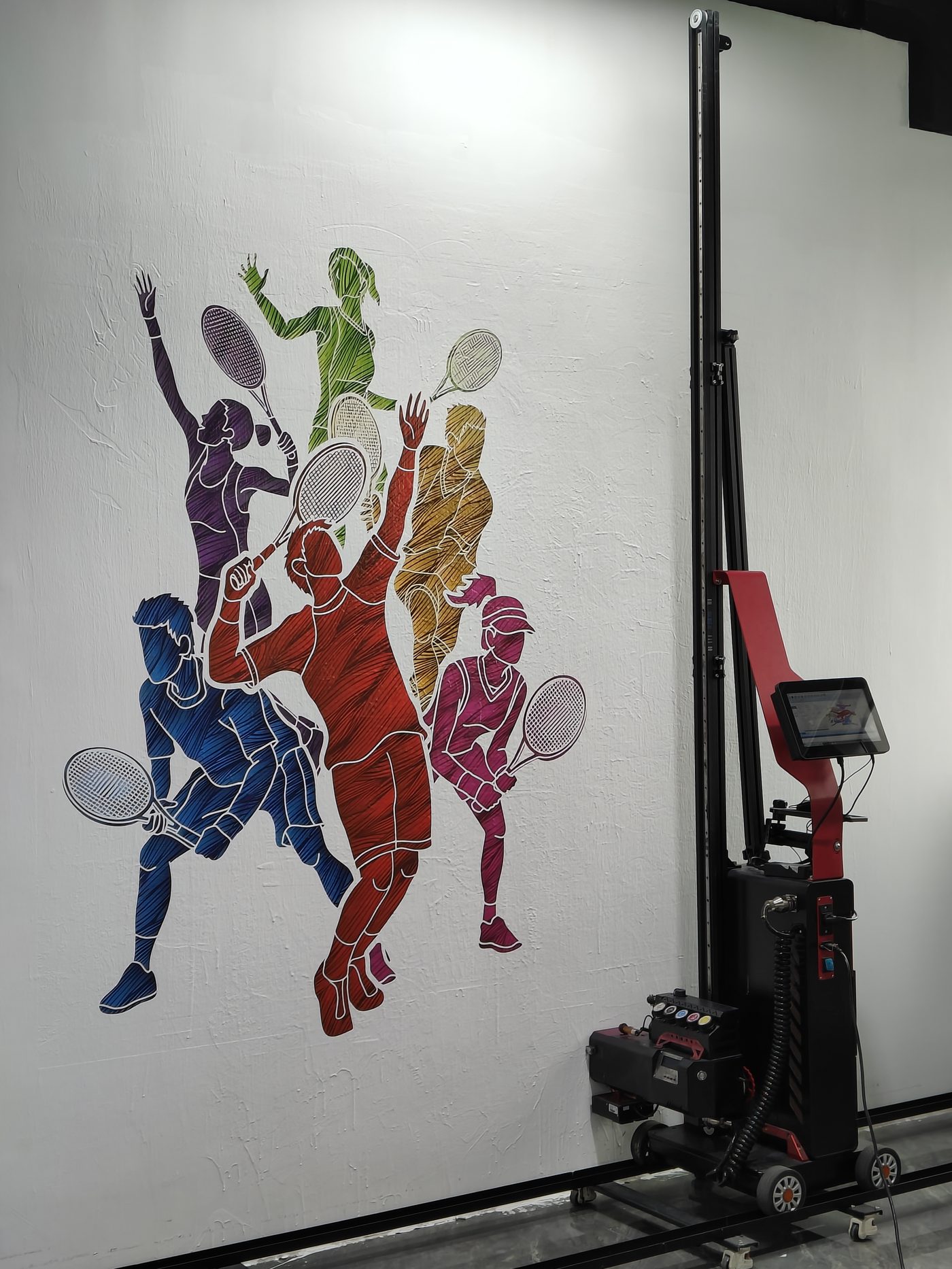 Large multi-color tennis mural printed directly onto a textured interior wall, with the printer on its rail alongside