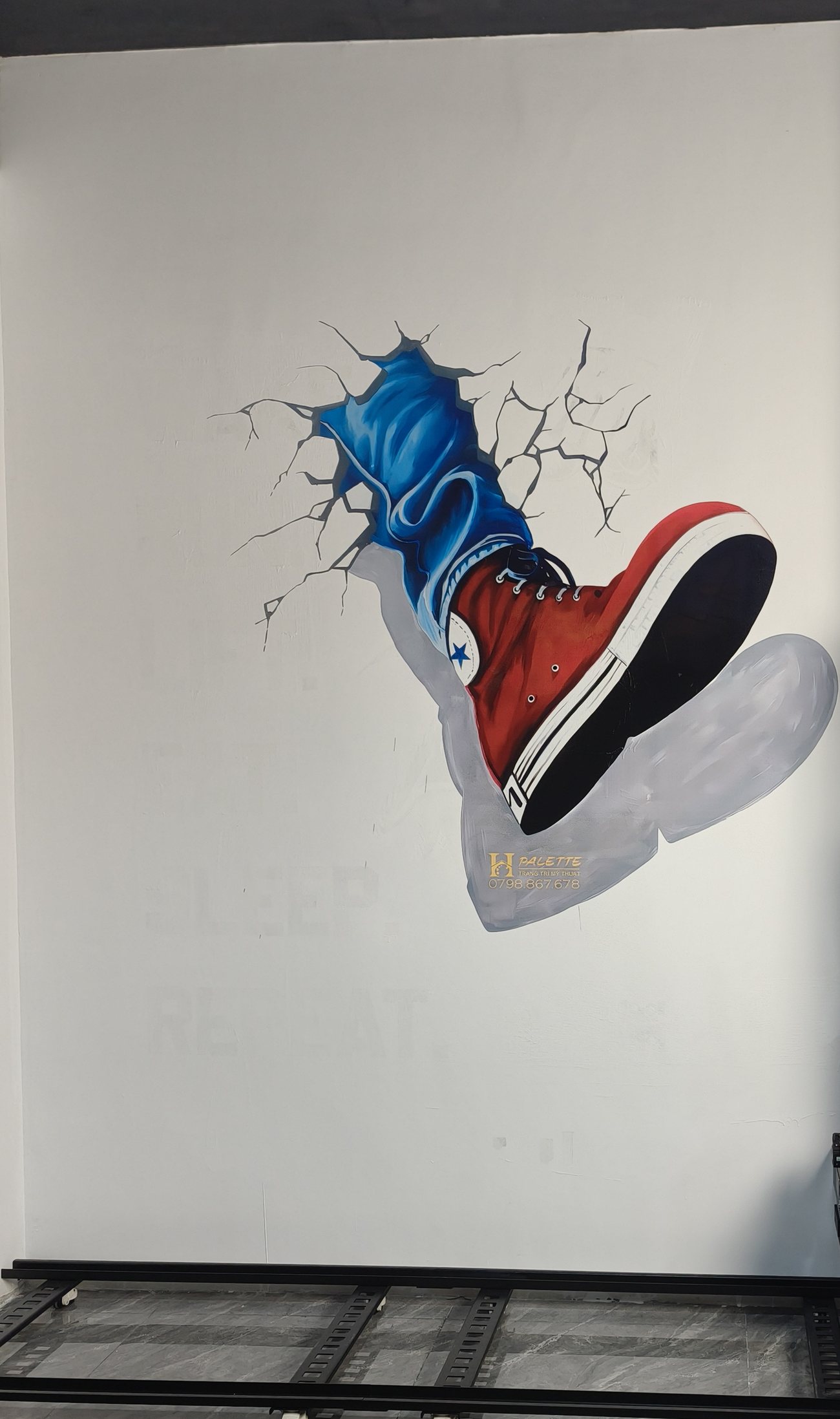 Trainer bursting through a wall in a three-dimensional effect