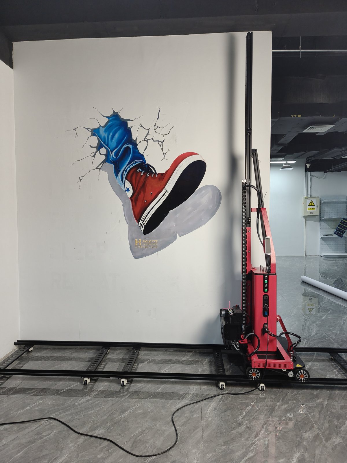 Trainer bursting through a wall in a three-dimensional effect, printed directly onto the surface