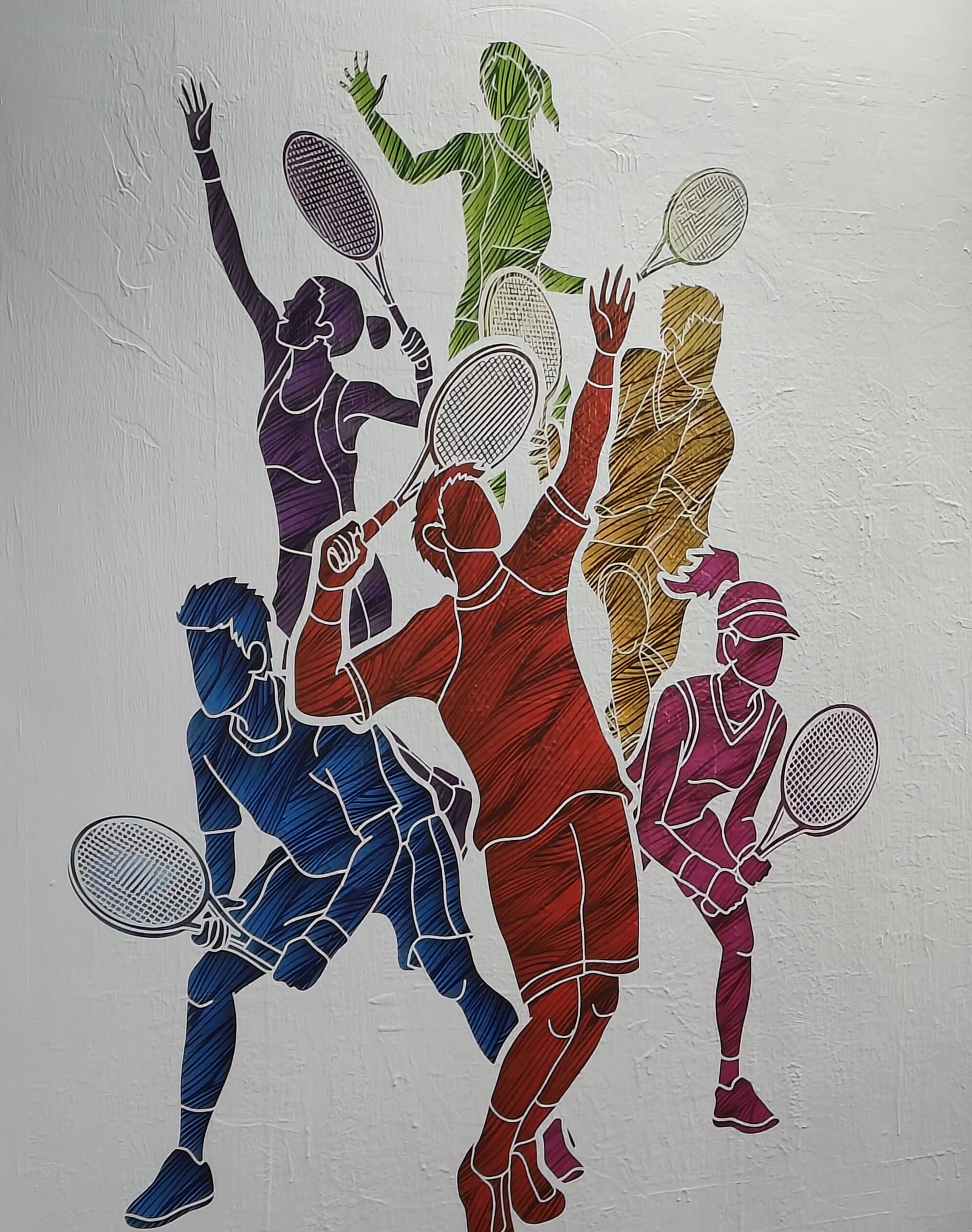 Multi-colored tennis players printed onto a textured interior wall